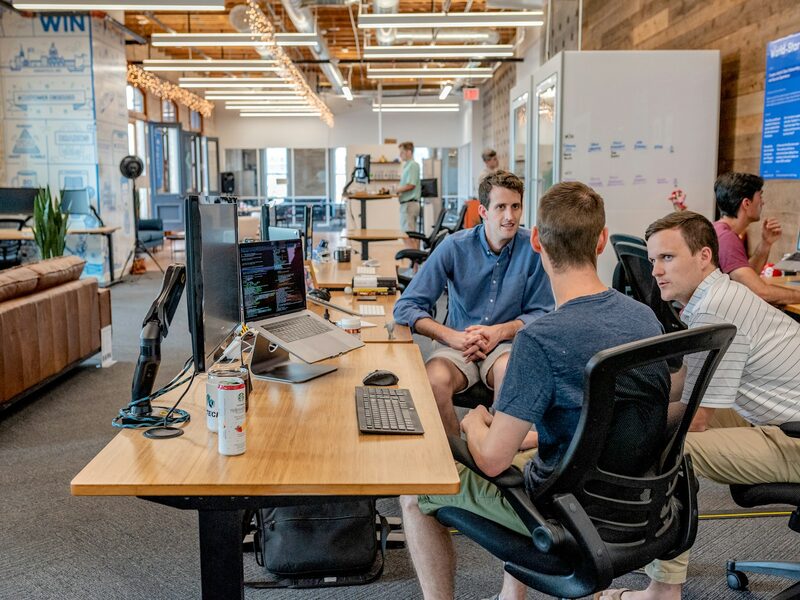 Young Clever Oak team members talking together in the Charleston office