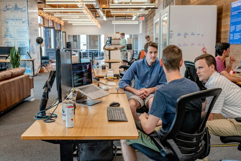 Clever Oak team discussing client growth plans in an open office