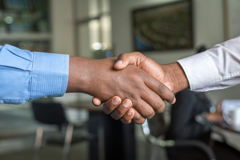 Two professionals shaking hands after agreeing a business partnership